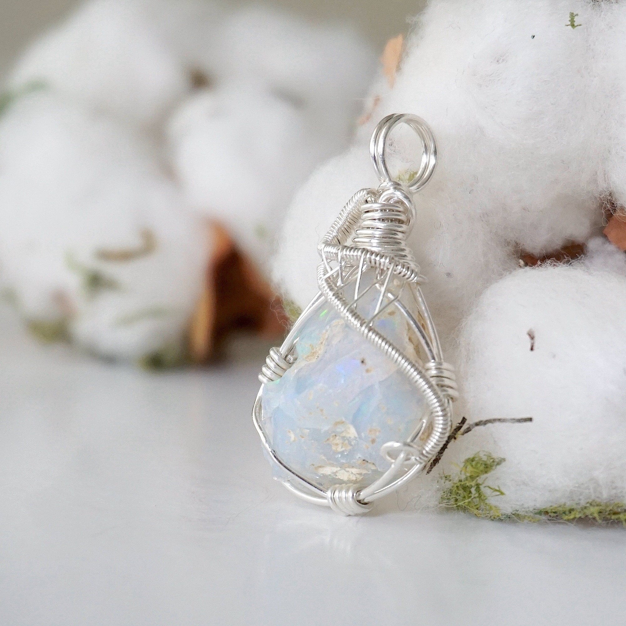 Left side angle detail of sterling silver opal pendant, artisan wire wrapped by Designs by Nature Gems.
