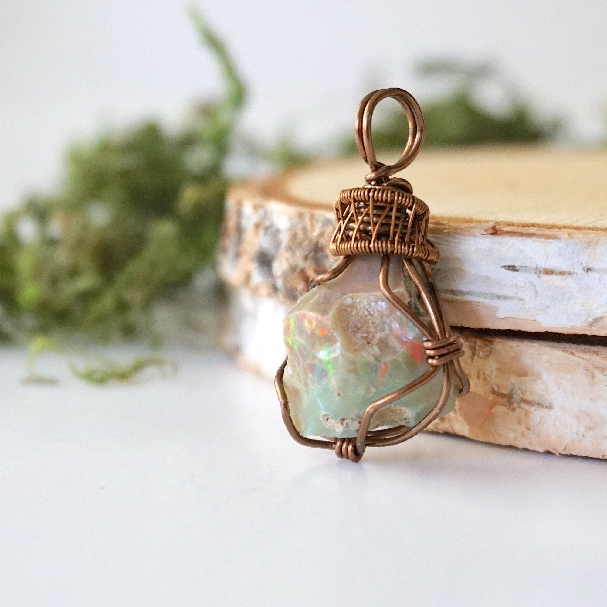 Side angle detail of natural opal pendant, wire wrapped in antique bronze copper by Designs by Nature Gems.