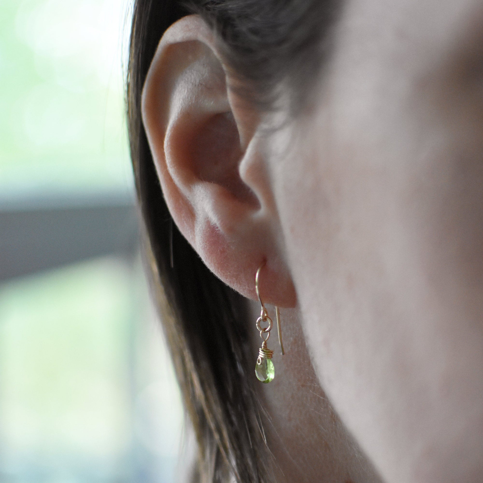 Peridot drop earrings on a female model, genuine faceted peridot, 14k gold filled