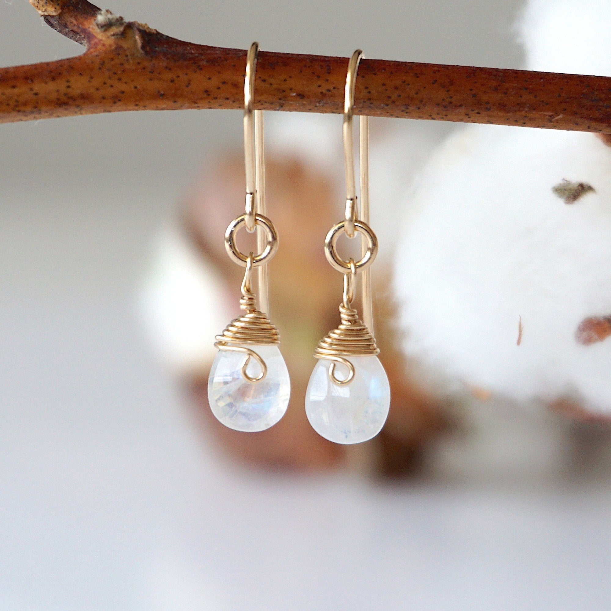 Detailed front view of rainbow moonstone drop earrings, genuine faceted rainbow moonstone with minimalist 14k gold filled wire wrapping, Designs by Nature Gems