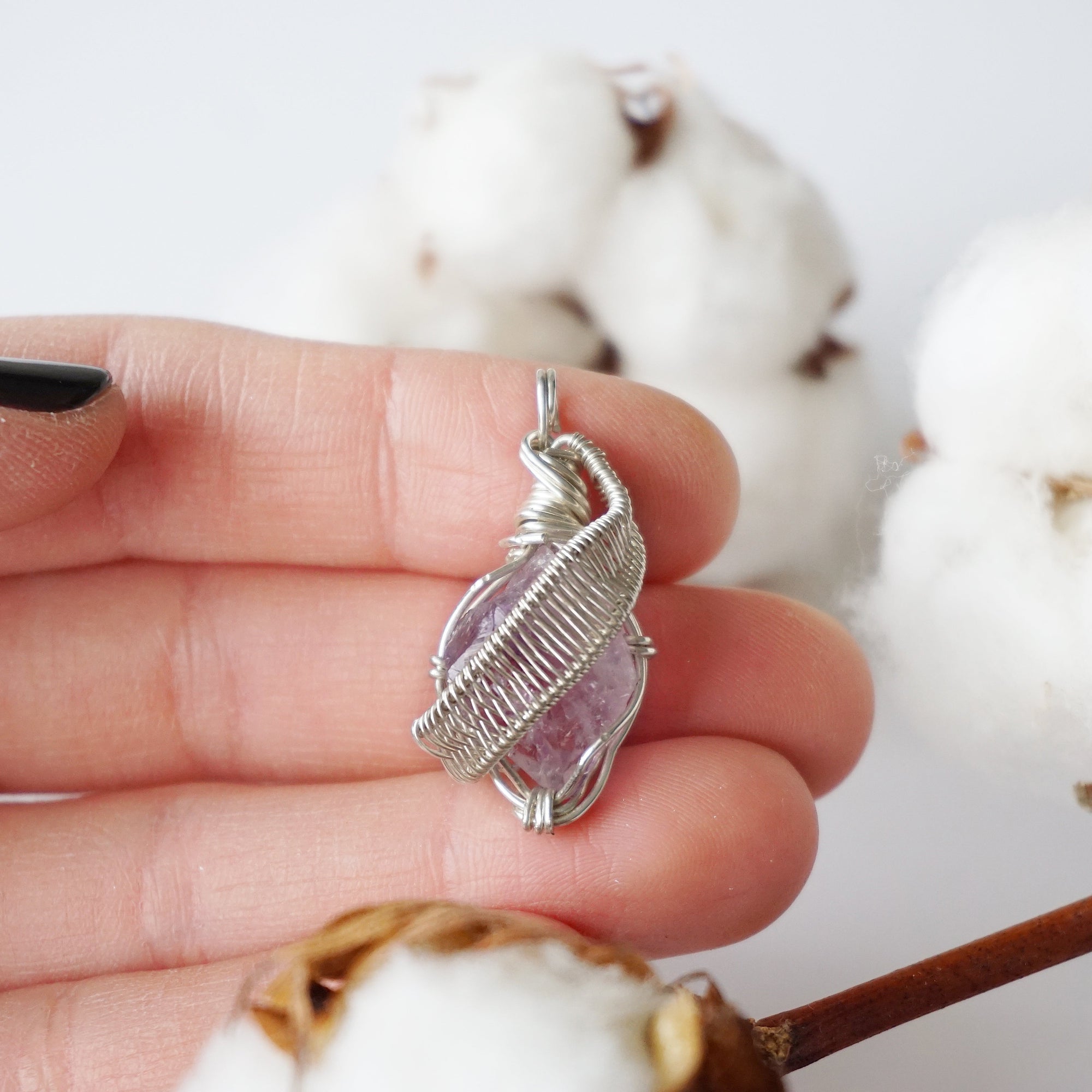 Raw amethyst necklace in hand for size reference, natural amethyst crystal, sterling silver artisan wire wrap