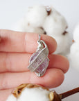 Raw amethyst necklace in hand for size reference, natural amethyst crystal, sterling silver artisan wire wrap