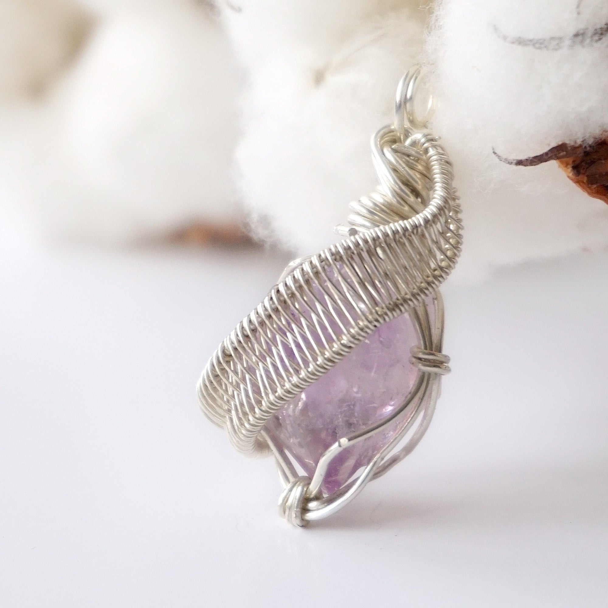 Left side angle of raw amethyst pendant, natural amethyst crystal, sterling silver artisan wire wrap