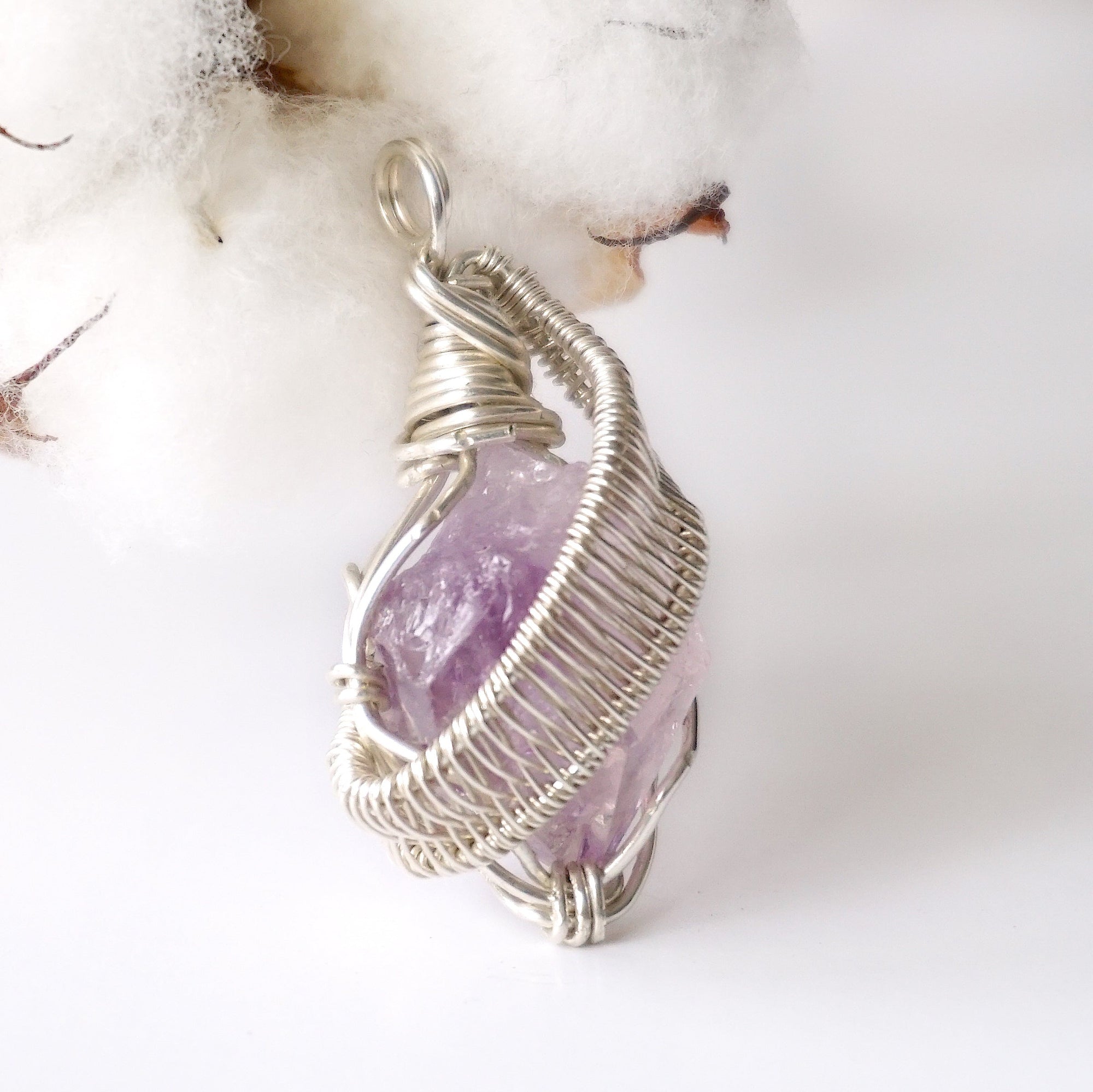 Right side angle of raw amethyst pendant, natural amethyst crystal, sterling silver artisan wire wrap