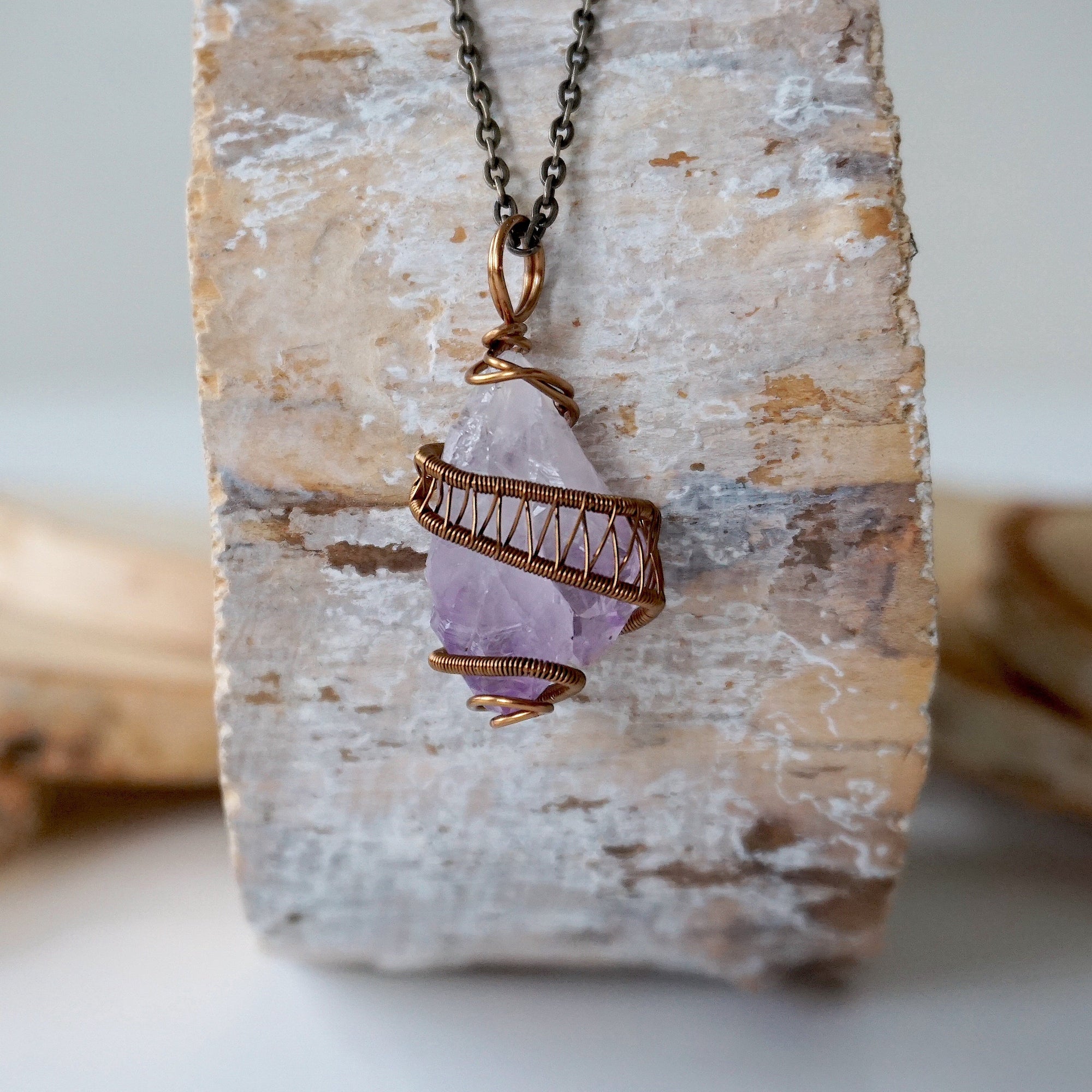 Front view of raw amethyst point necklace with detailed antique bronze copper wire wrap on antique bronze chain