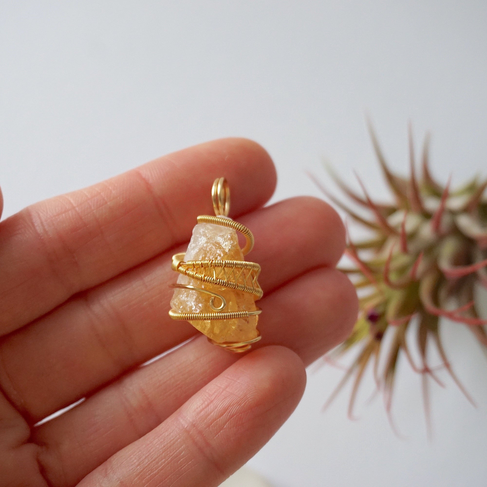 Raw citrine pendant held in hand showing size scale - natural unpolished crystal wire wrapped in gold plated copper handmade necklace size reference