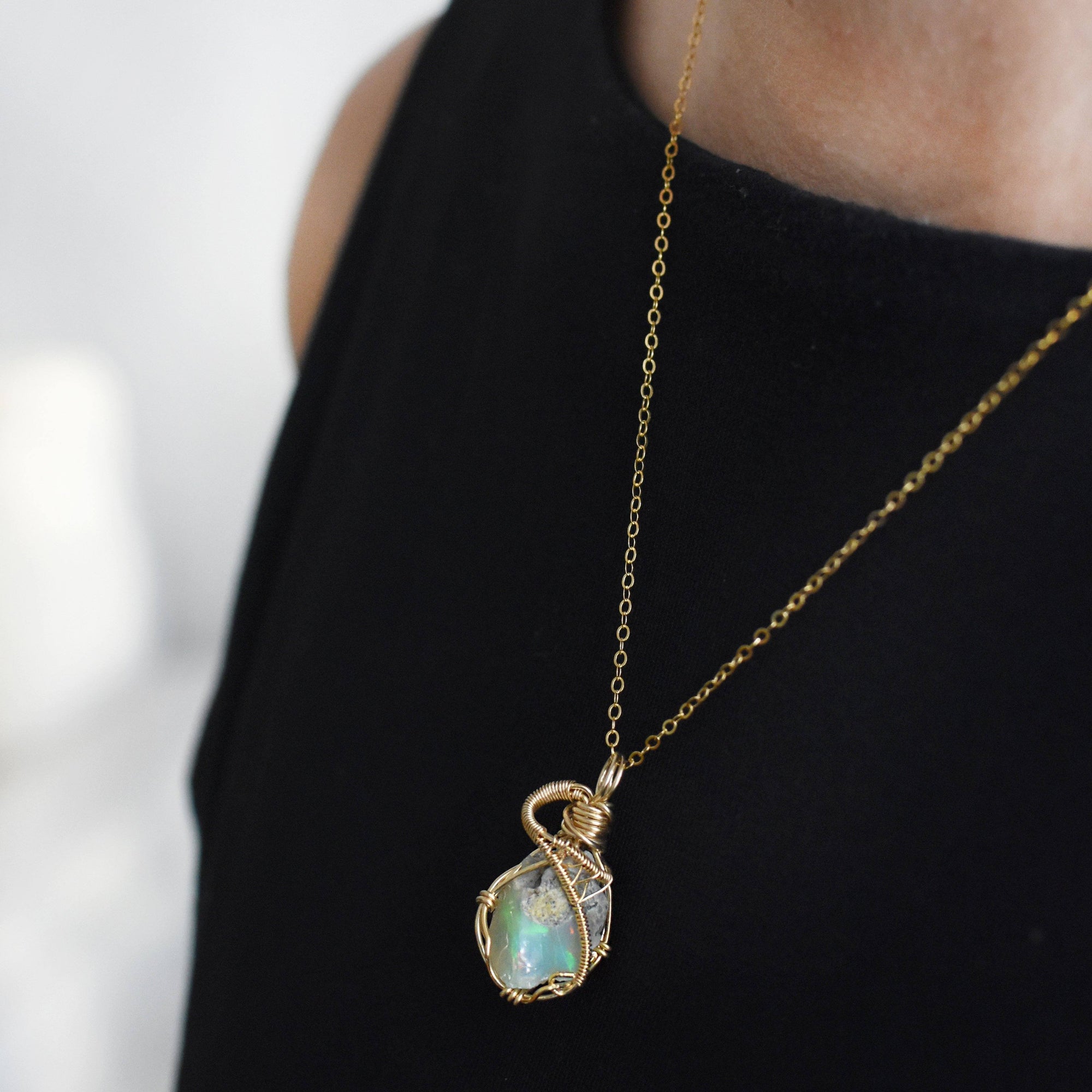 Raw opal necklace in 14k gold filled on a female model. Handcrafted October birthstone jewelry for women by Designs by Nature Gems.