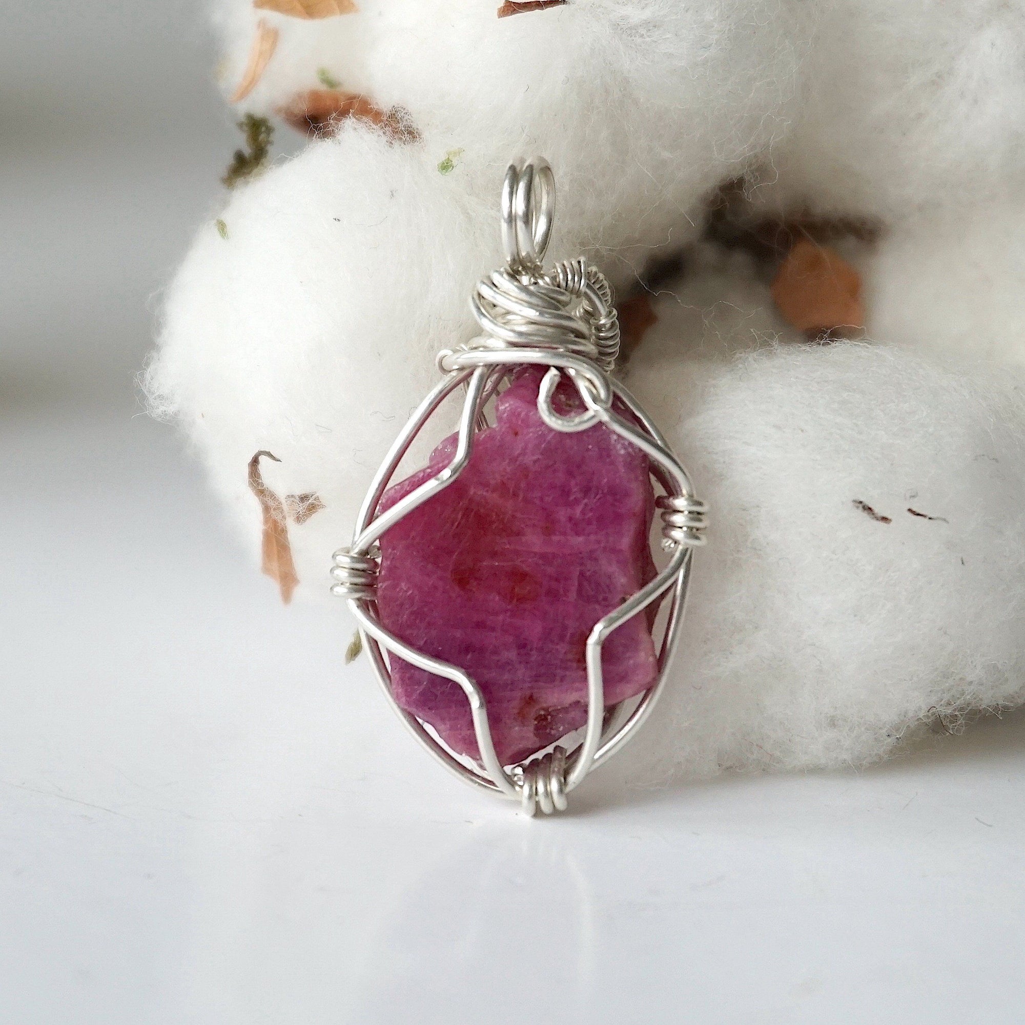 Back side angle of raw ruby pendant, natural pink ruby, sterling silver artisan wire wrapping