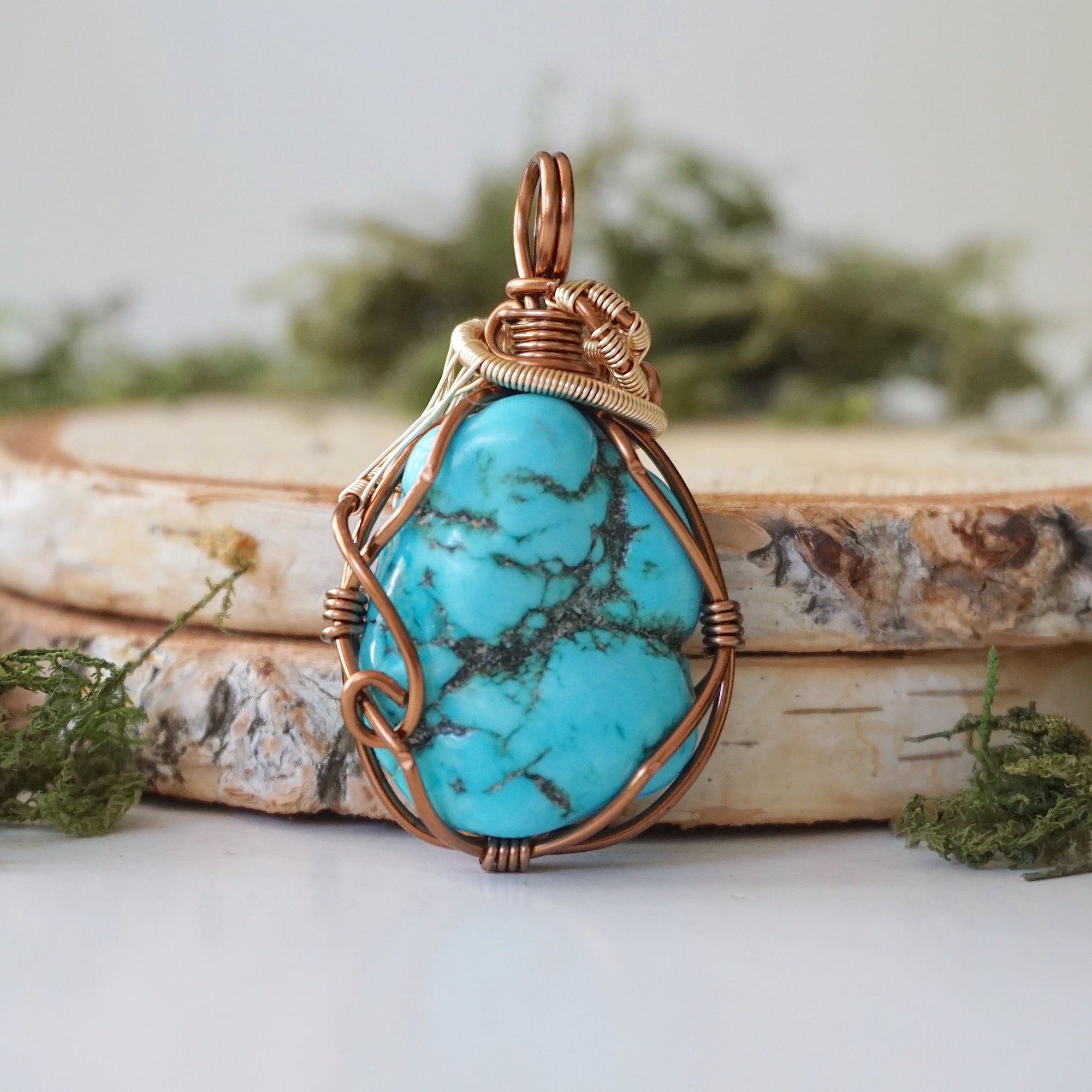 Back view raw turquoise pendant showing complete wire wrap and bail detail