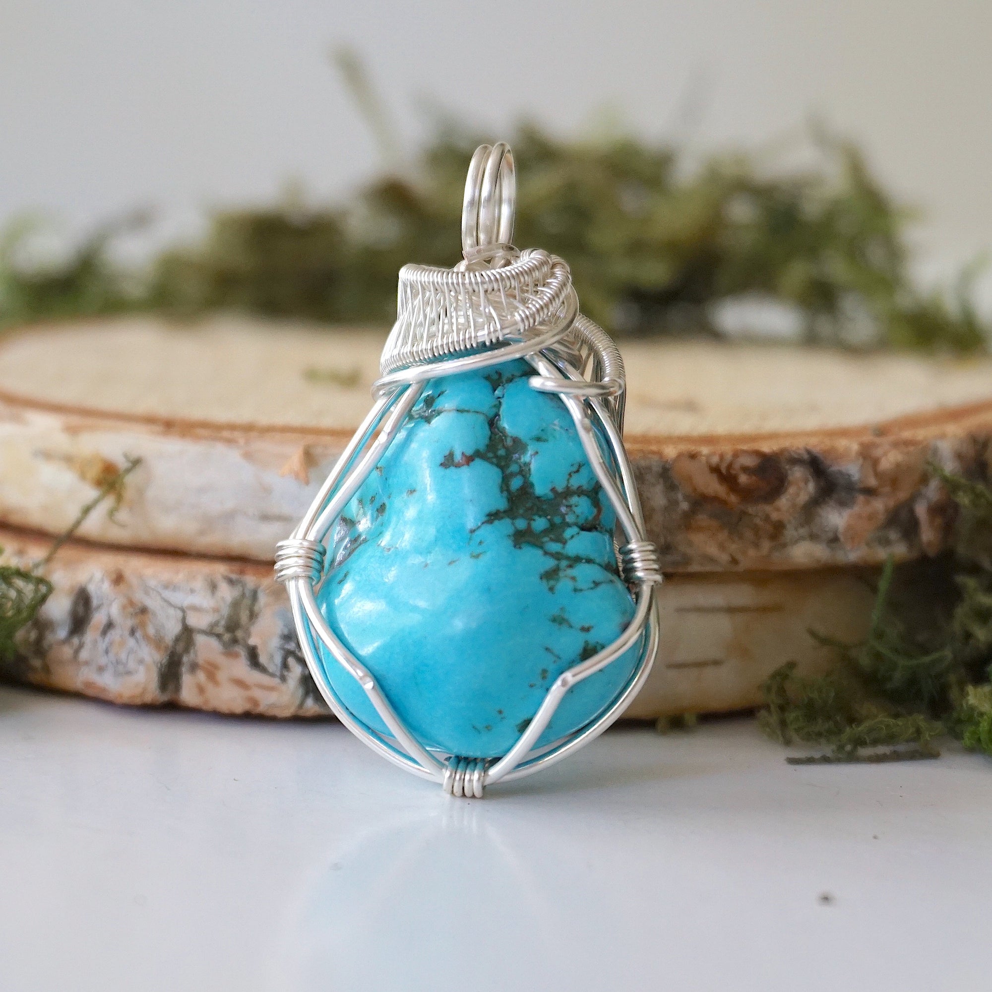 Back view raw turquoise pendant showing complete wire wrap and bail detail