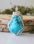 Back view raw turquoise pendant showing complete wire wrap and bail detail