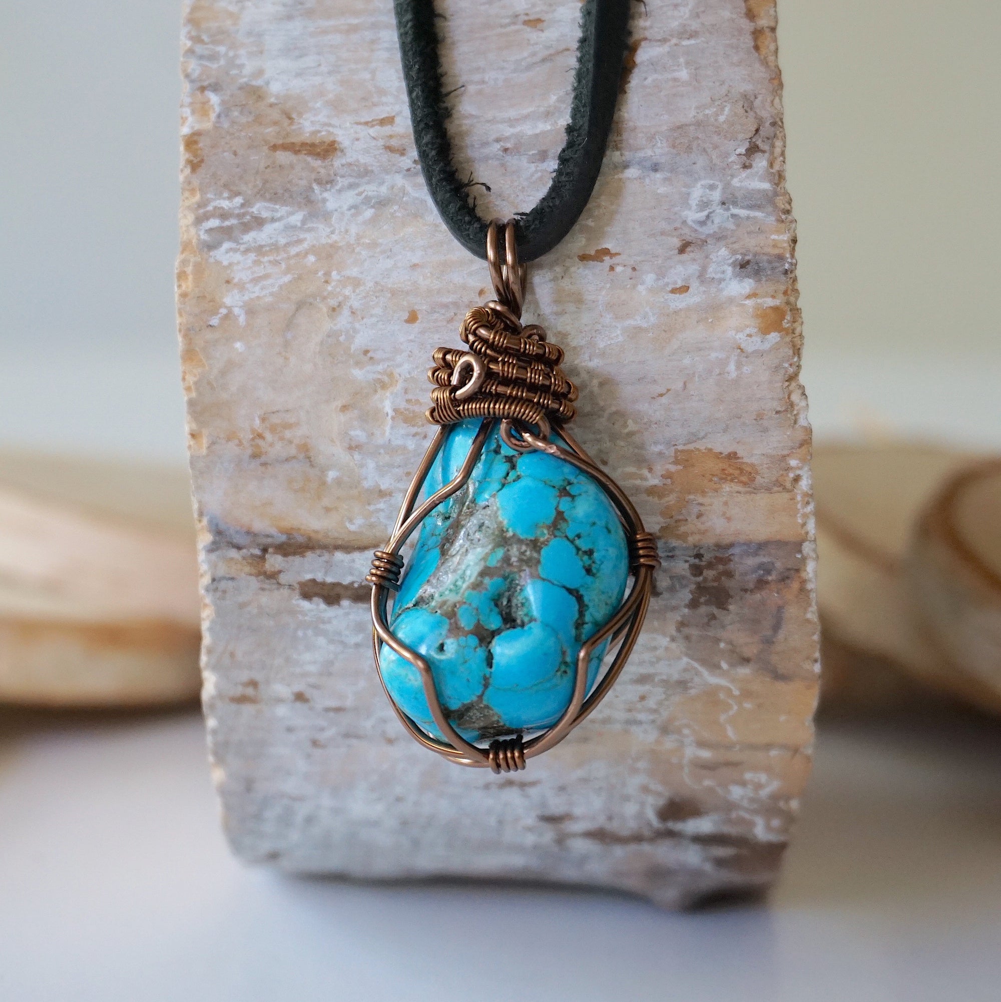 Raw turquoise pendant men copper wire wrapped back side showing secure wrap