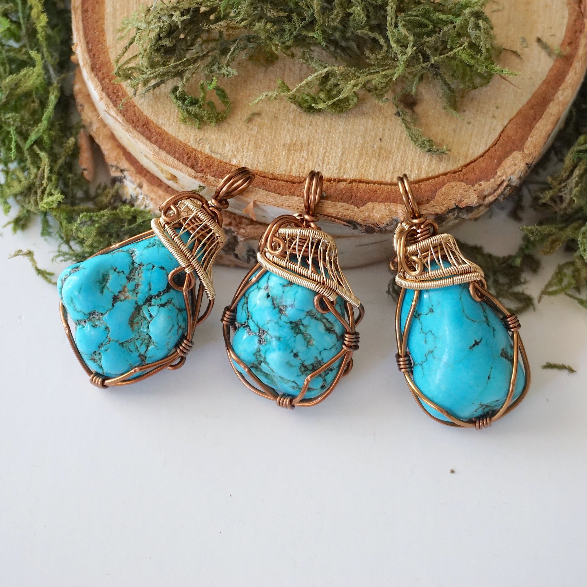 Three raw turquoise pendants showing natural stone color and shape variations