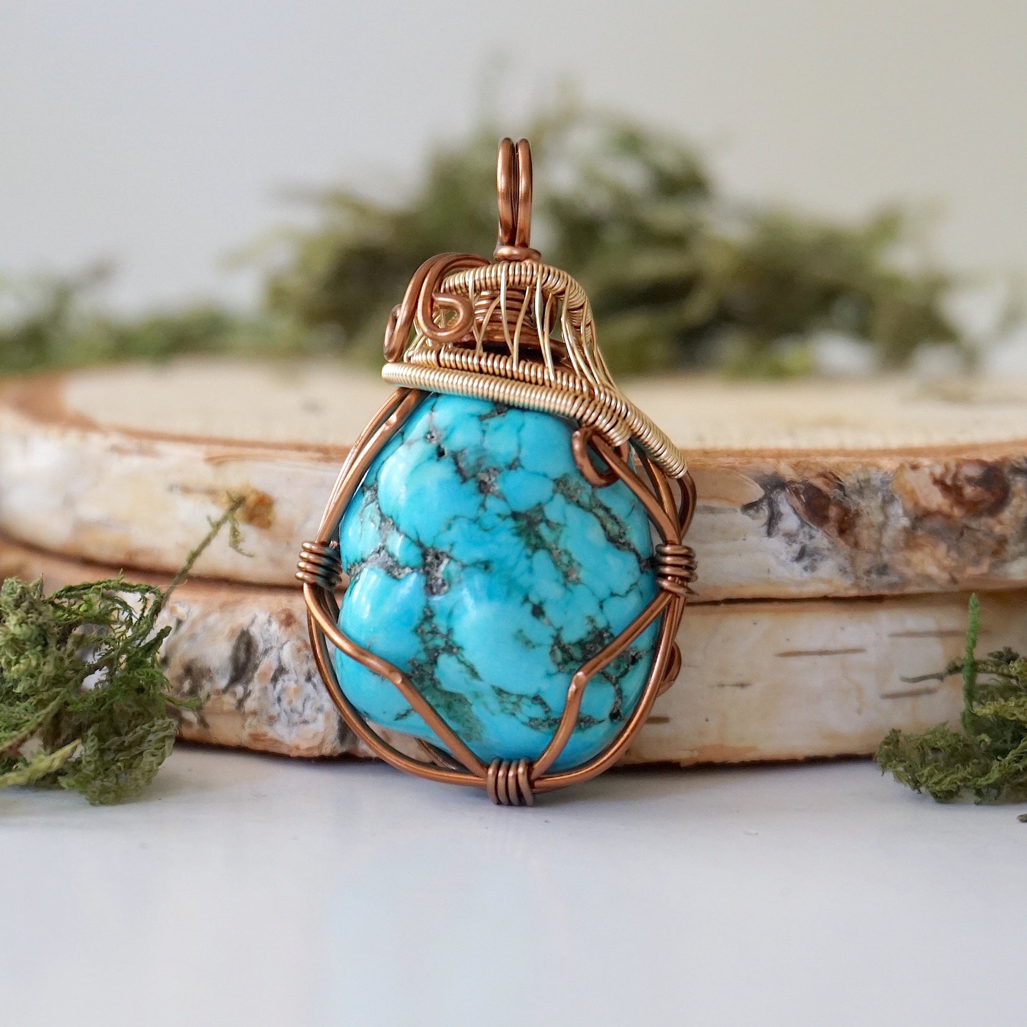 Front view raw turquoise pendant with detailed bronze gold wire wrapping art
