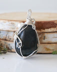 Back detail of silver wire wrapped shungite and freshwater pearl pendant necklace, handcrafted gemstone jewelry