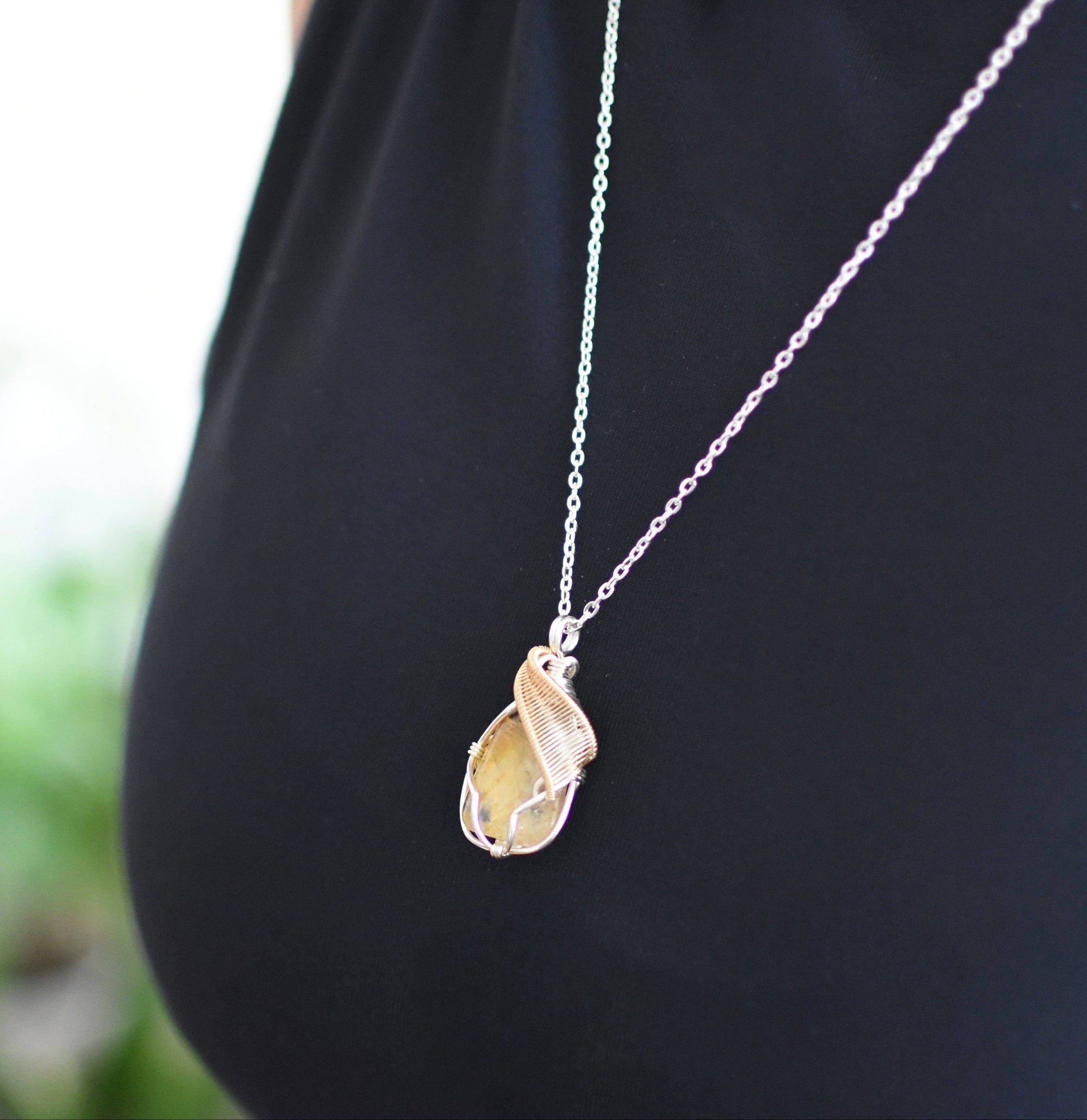 Side view of woman wearing silver gold plated citrine pendant necklace - two tone wire wrapped crystal healing jewelry