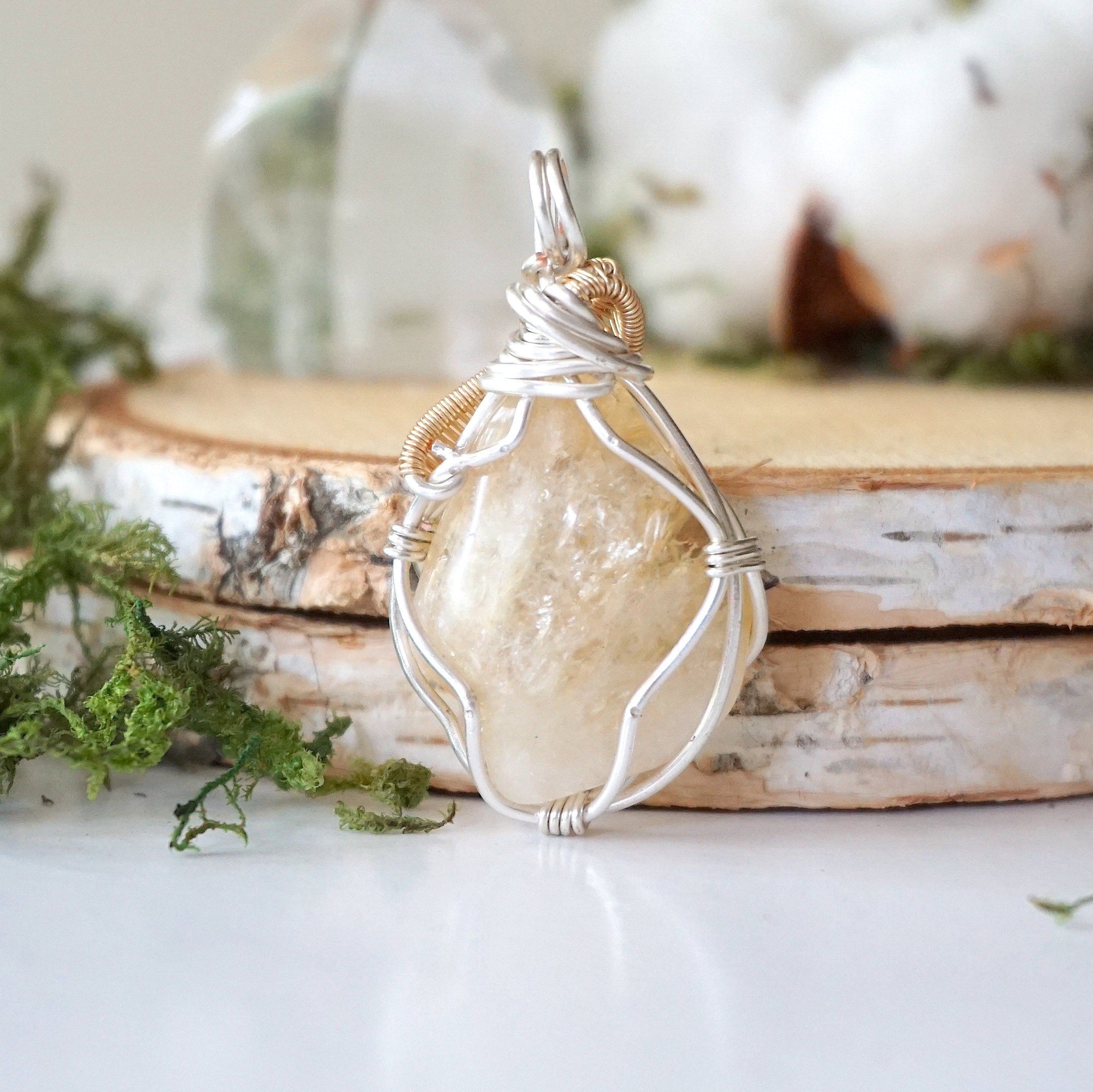 Back view of wire wrapped citrine necklace showing silver gold plated copper wire detail and artisan craftsmanship