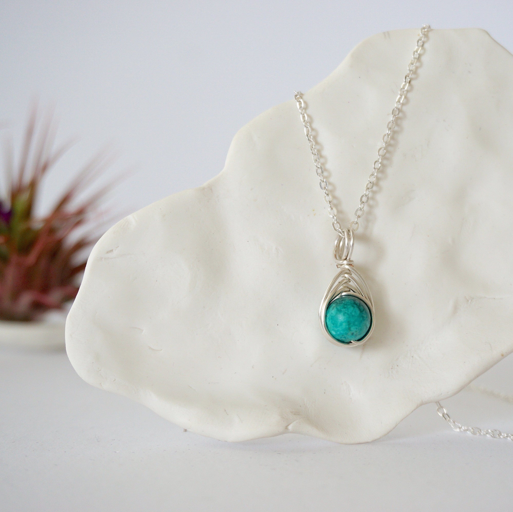 Silver plated turquoise pendant necklace front view showing wire wrapped stone