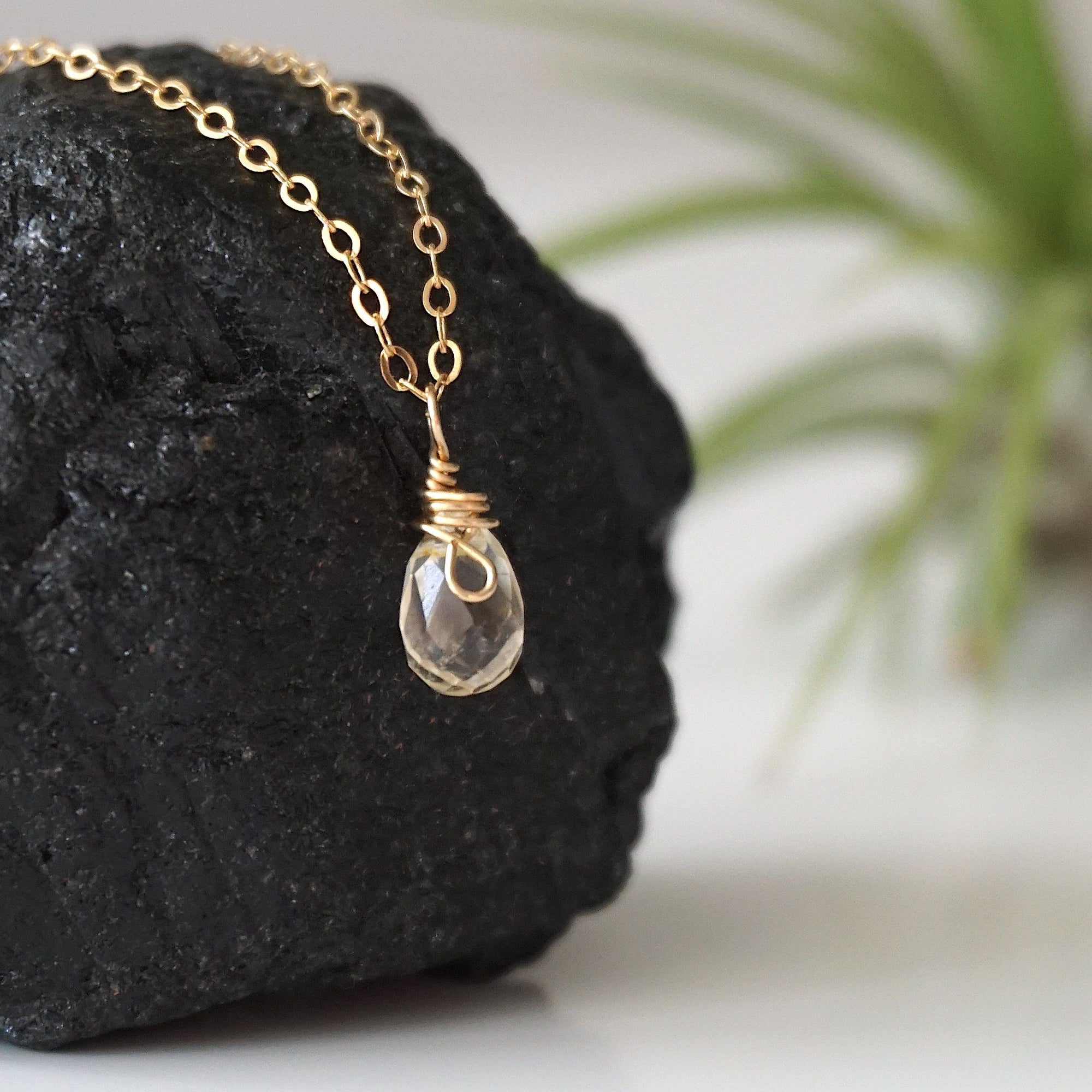 Side view of small citrine pendant 14k gold filled showing delicate wire wrapping and natural raw crystal
