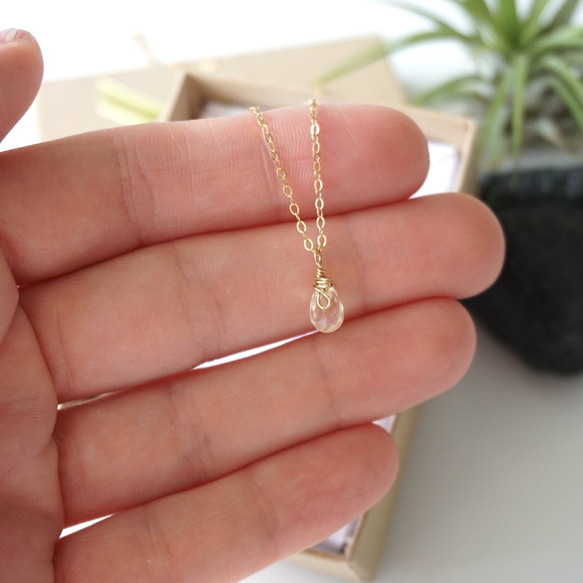 Small citrine pendant held in hand showing 0.5 inch size delicate 14k gold filled necklace for women
