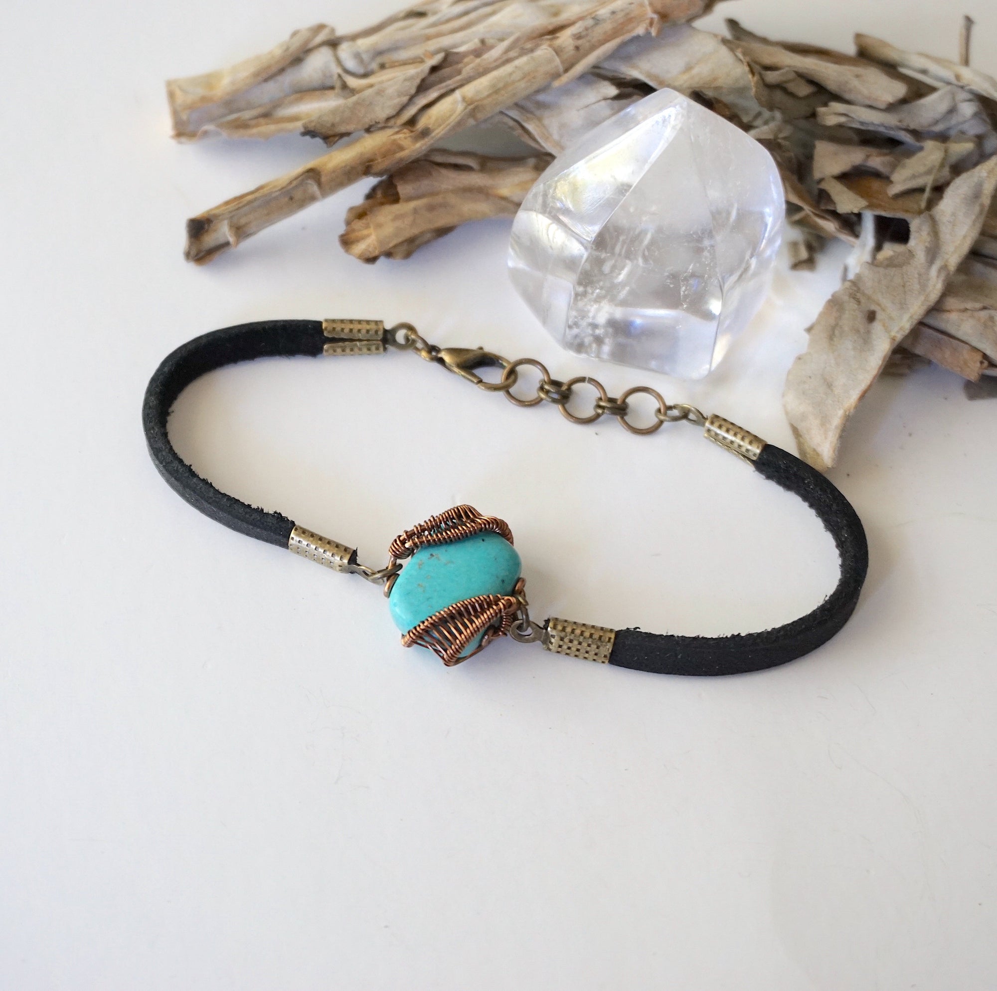 Left side view of raw turquoise bracelet showing natural stone variations and genuine leather strap, handcrafted wire wrapped jewelry