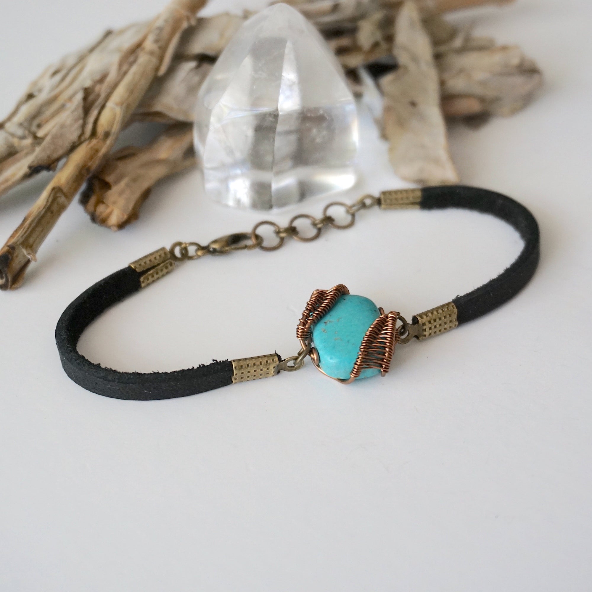 Right side view of natural turquoise stone with detailed antique bronze wire wrapping on leather bracelet, handmade artisan detail

