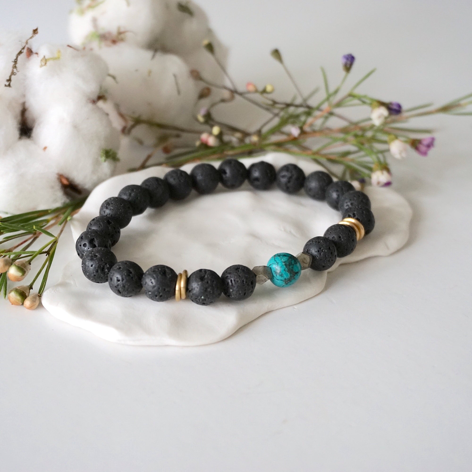 Turquoise lava bead mala bracelet with pyrite side view showing gold disks