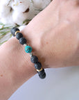 Turquoise lava bead mala bracelet with pyrite worn on woman's wrist lifestyle