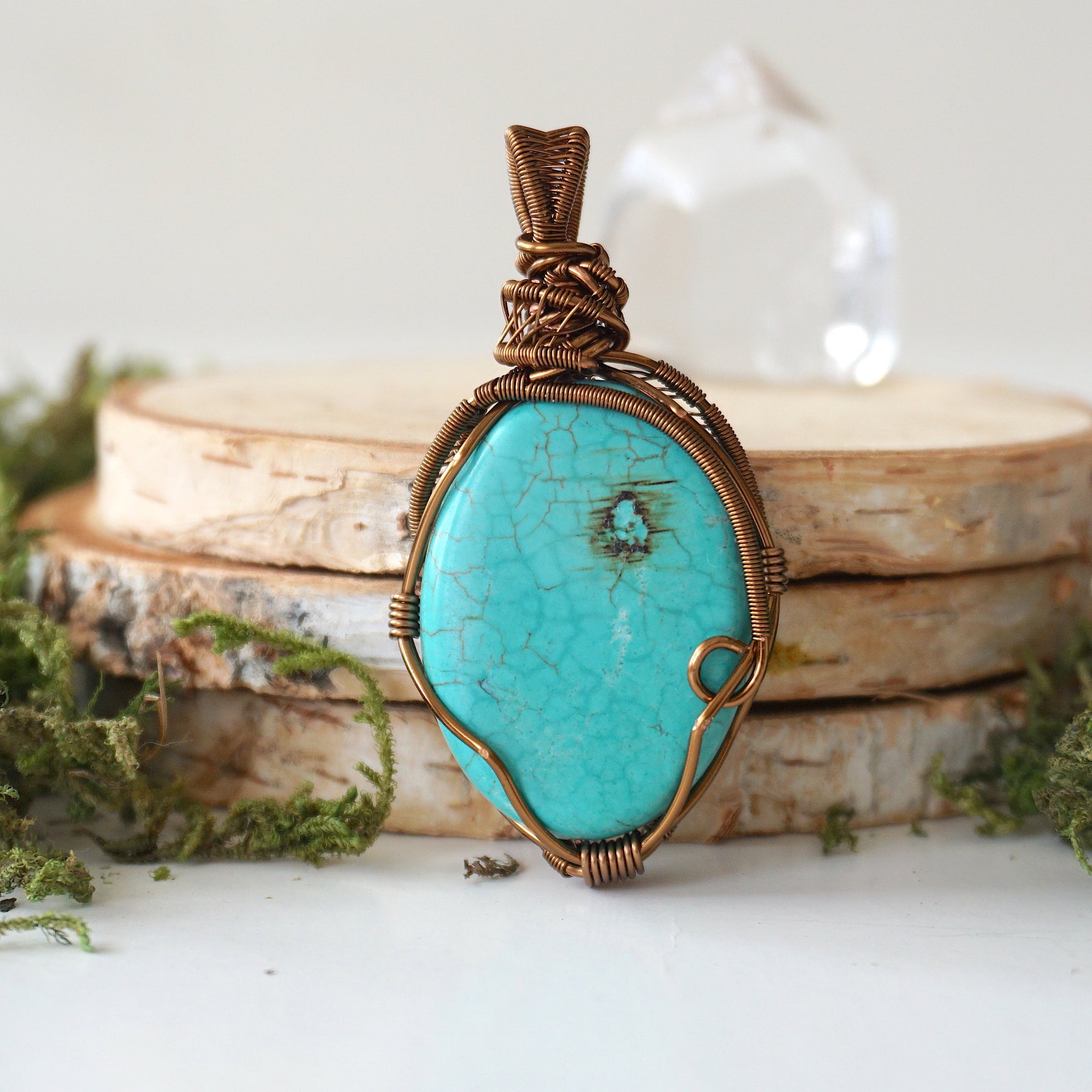 Back view of natural turquoise pendant revealing intricate wire work and artisan craftsmanship in antique bronze copper wire