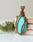 Side profile of handmade turquoise pendant showing detailed wire wrapping technique and natural stone depth in antique bronze
