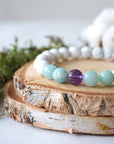 Close up side angle of white howlite, amethyst, and amazonite stretch bracelet, 8mm gemstone beads, calming jewelry