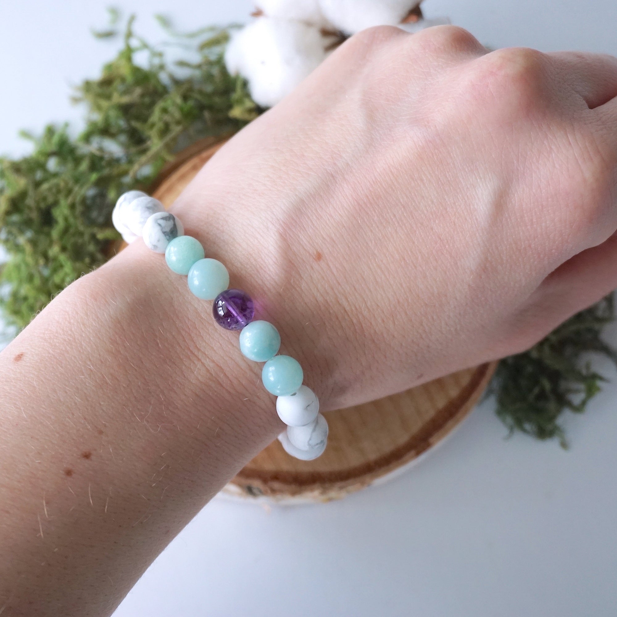 White howlite, amethyst, and amazonite beaded bracelet shown on a model’s wrist, stretch fit, calming crystal jewelry for women