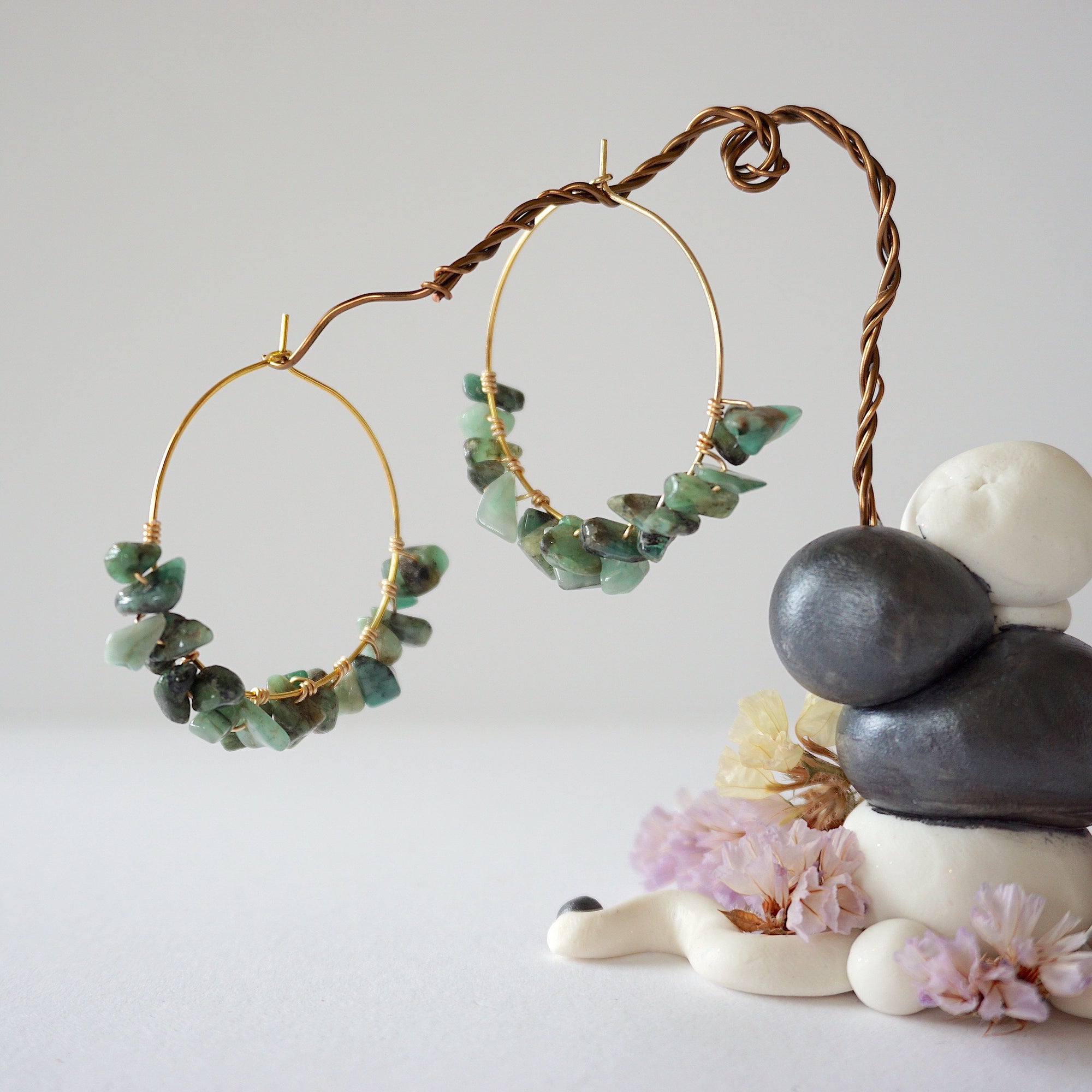 Wire wrapped emerald hoop earrings in warm gold copper with natural emerald chips and handcrafted artisan design