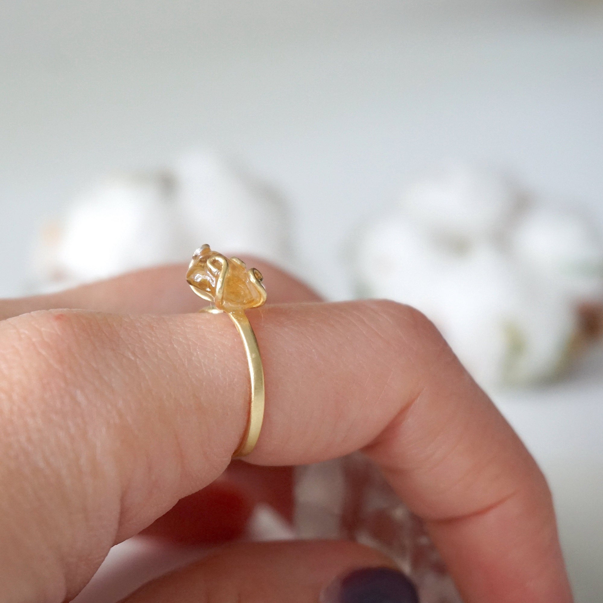 Woman wearing adjustable citrine ring 14k gold vermeil on finger - natural crystal wire wrapped handmade ring November birthstone styled on hand